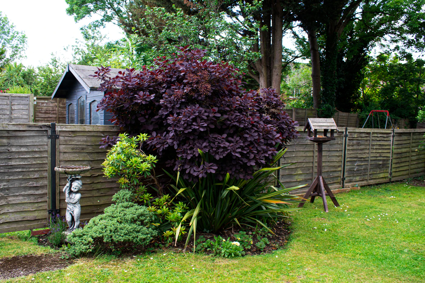 Jardin fermé par une clôture en bois (photo d'illustration)